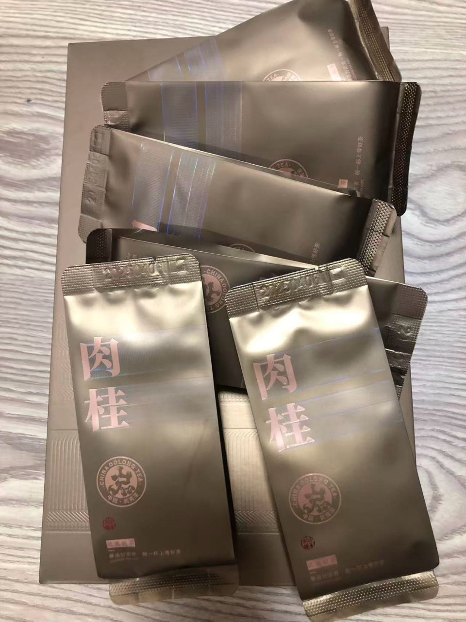 Zhengyan Rou Gui oolong tea sachets, gold packaging