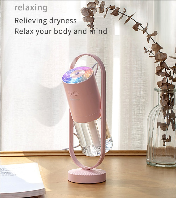 Pink USB Cool Mist Humidifier in use with projection light