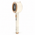 Beige mini handheld garment iron with champagne-colored trim; US plug option, cable not pictured